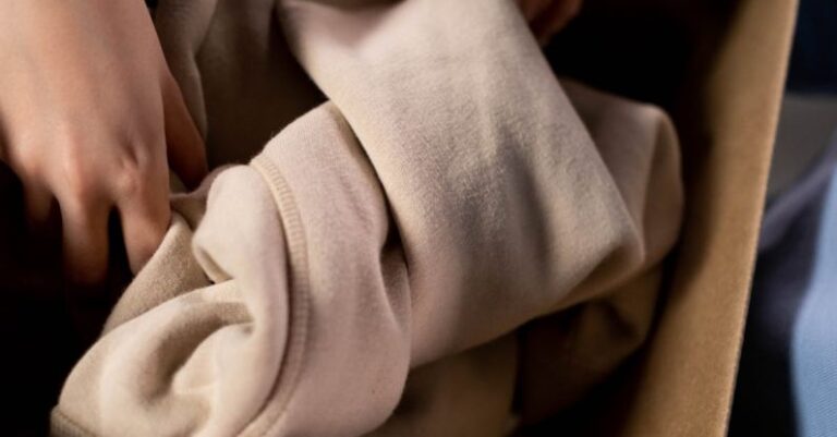 Community Service - Person Holding a Brown Box with Clothing