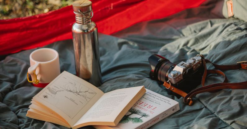 Camp Gadget - Thermos books and photo camera on camp tent