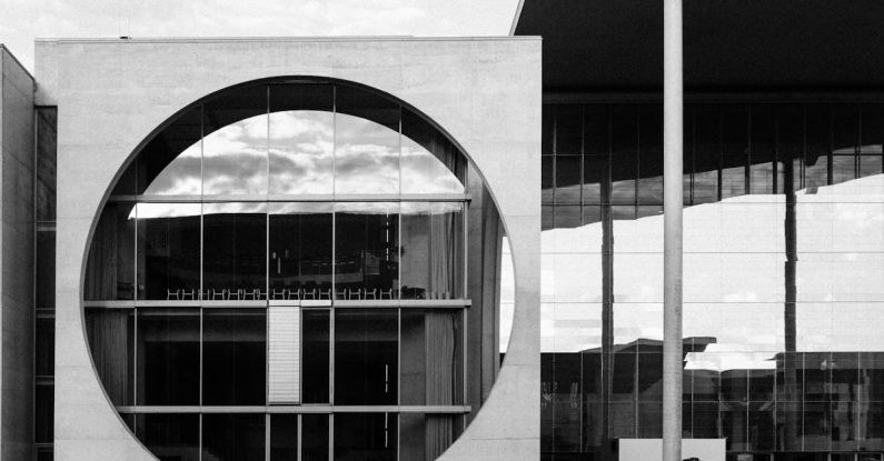 Local Authorities - Grayscale Photo of Building Near Body of Water