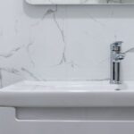 Water Sources - Modern bathroom interior with white washbasin and tap under mirror reflecting water heater at home