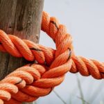 Knots - Orange Rope Wrapped Brown Wood Log