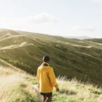 Solo Hiking - Back View of a Man Standing in a Footpath Towards the Hills
