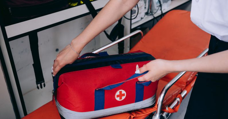 First Aid Kit - A Person Holding a First Aid Kit on a Stretcher