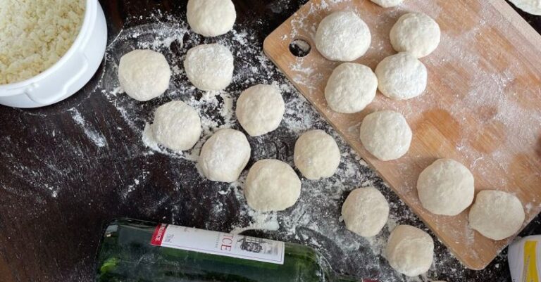 Cooking Techniques - A table with dough, flour and a bottle of wine